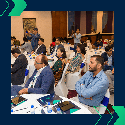 Attendees seated at tables, attentively listening to a session during the Jayesh Logistics Conclave on November 18, 2024.